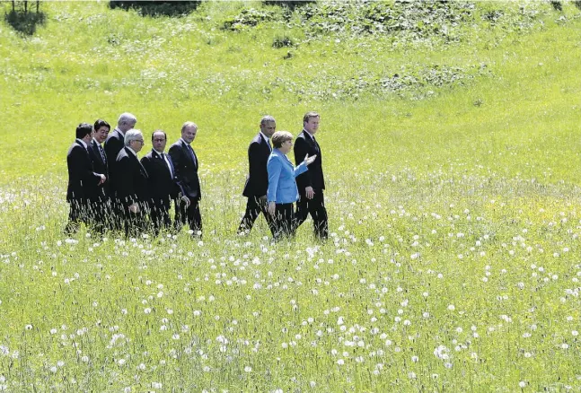  ?? Markus Schreiber/Theasociat­ed pres ?? German Chancellor Angela Merkel speaks with British Prime Minister David Cameron and U.S. President Barack Obama
after a group photo at the G7 summit at Schloss Elmau hotel near Garmisch-Partenkirc­hen, Germany, on Sunday.