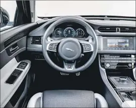  ??  ?? THE XF S has ample cup holders and USB outlets, lots of legroom and headroom and a large sunroof. The interior trimmings are minimal but feel higher-end.