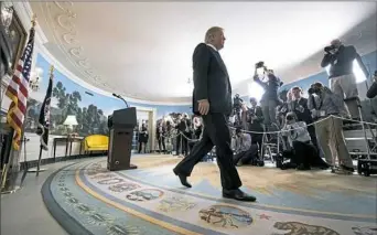  ?? Doug Mills/The New York Times ?? President Donald Trump leaves a White House press conference Friday after announcing that he wants Congress to toughen regulation­s governing the Iran nuclear deal and asking other nations to fix deficience­s in the agreement.