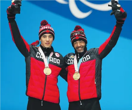  ?? NAOMI BAKER/GETTY IMAGES ?? Gold medallist Brian McKeever, right, and guide Graham Nishikawa celebrate Monday after winning the men’s 20-kilometre cross-country skiing event, visually impaired. at the Paralympic Games. The win means McKeever becomes Canada’s most decorated winter...