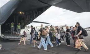  ?? PHOTOGRAPH: AUSTRALIAN DEPARTMENT OF DEFENCE ?? Tourists boarding an Australian rescue flight in Noumea