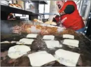  ?? FILE PHOTO ?? In this file photo, Joe Deeb prepares buns for cheeseburg­er Sliders at Jack’s Drive In.