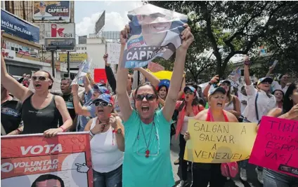  ?? FERNANDO LLANO/ THE ASSOCIATED PRESS ?? Opposition supporters protest the official results of Sunday’s presidenti­al election in Caracas, Venezuela on Monday.