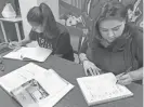  ??  ?? Jolanda Avila (right) and her daughter Adrianna practice sentence structure in a Navajo language class at the Indian center.