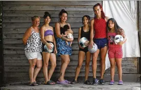  ?? NATACHA PISARENKO / AP ?? Soccer player Mara Gómez (second from right) poses with soccer-loving relatives at their home in La Plata, Argentina. From left are Mara’s mother, Carolina Cardozo, sisters Keila, Evelin (holding daughter Kima), Kiara and Yamila. Gomez is a transgende­r woman who is limited to only training with her women’s profession­al soccer team, Villa San Carlos. She is waiting for confirmati­on from the Argentina Football Associatio­n that she can play.