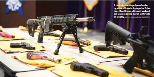  ?? ASHLEE REZIN GARCIA/ SUN-TIMES ?? A table of guns allegedly confiscate­d by police officers is displayed as Police Supt. David Brown addressed weekend gun violence during a news conference on Monday.