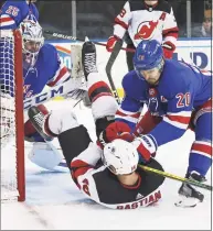  ?? Bruce Bennett / Associated Press ?? The Rangers’ Chris Kreider (20) hits the Devils’ Nathan Bastian after he collided with Rangers goalie Igor Shesterkin during the third period Saturday.