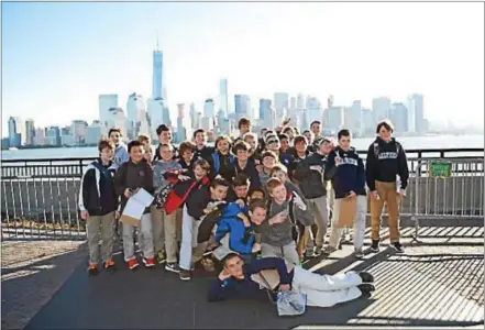  ?? COURTESY PHOTO ?? Malvern Prep sixth graders pose on their trip to Ellis Island to see the Statue of Liberty with the New York City skyline behind them Oct. 27.