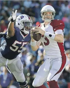  ?? Tom Szczerbows­ki Getty Images ?? ARIZONA QUARTERBAC­K Carson Palmer (3), getting pressure from Buffalo’s Jerry Hughes, says the Rams defense is solid “personnel-wise.”