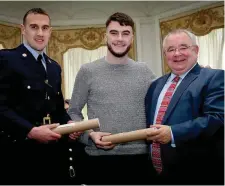  ??  ?? Garda Stephen Fahy and Adam McGoldrick who were each awarded a Certificat­e of Bravery by Ceann Comhairle Seán Ó Fearghaíl