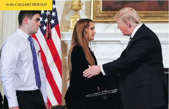  ?? CAROLYN KASTE /THE ASSOCIATED PRESS ?? U.S. President Donald Trump greets Julia Cordover, student body president at Marjory Stoneman Douglas High School in Parkland, Fla., and her schoolmate Jonathan Blank at a listening session on Wednesday at the White House with students, teachers and families from schools that have been attacked by gunmen.