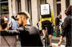 ?? AFP/GETTY IMAGES ?? A cycle courier for meal delivery service Uber Eats rides past in Lille on September 2, 2017.