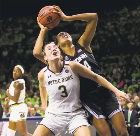  ?? Robert Franklin / Associated Press ?? UConn’s Napheesa Collier shoots over Notre Dame’s Marina Mabrey during the first half of Sunday’s game in South Bend, Ind.