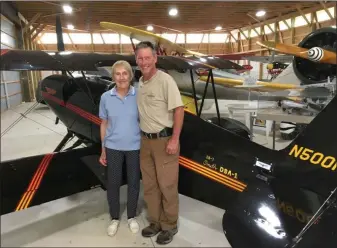  ?? JANET PODOLAK — THE NEWS-HERALD ?? Leroy Heritage Associatio­n member Gretchen Reed and Airport Manager Chris Joles stand next to a Smith Miniplane designed for sport flying.