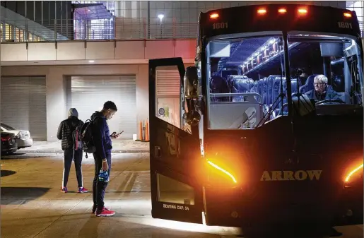  ?? PHOTOS BY CHAD RHYM/THE NEW YORK TIMES ?? The Jackson State men’s basketball team departs by bus after facing the University of Northern Iowa in Cedar Falls, Iowa, on Dec. 14. Some historical­ly Black colleges and universiti­es travel for most or all of their nonconfere­nce games, drawing guaranteed paydays to help bolster some of the smallest athletic budgets in NCAA Division I sports.