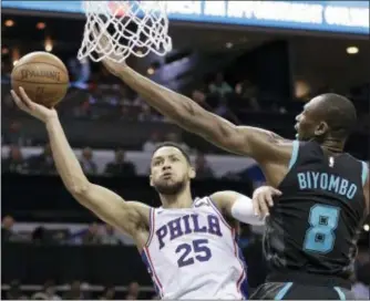  ?? CHUCK BURTON — THE ASSOCIATED PRESS ?? Philadelph­ia 76ers’ Ben Simmons (25) drives against Charlotte Hornets’ Bismack Biyombo (8) during the second half in Charlotte, N.C., Tuesday.