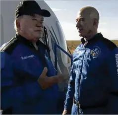  ?? BLUE ORIGIN ?? William Shatner (left) talks with Amazon founder Jeff Bezos about his experience after exiting the Blue Origin capsule Wednesday near Van Horn, Texas. Shatner became the oldest person in space.