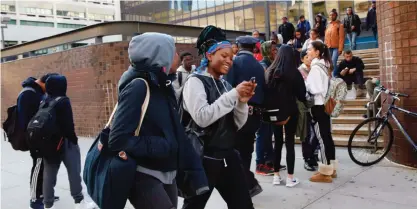  ??  ?? NEW YORK: Students chat as they leave Martin Luther King Jr High School on Tuesday. Martin Luther King is one of 88 New York City schools requiring students to pass through metal detectors before entering. — AP photos