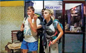  ??  ?? Two tourists, with tickets booked online, at the Fort Railway Station after they were stranded on Thursday owing to a strike by railway workers. Pic by M.A. Pushpa Kumara