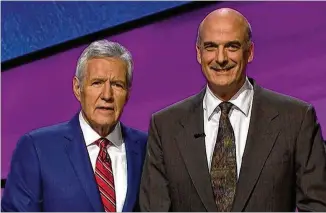  ?? JEOPARDY PRODUCTION­S, INC. ?? Alan Dunn, a 59-year-old software developmen­t manager from Johns Creek, has been watching ‘Jeopardy!’ since he was a kid. On Friday, finally appearing alongside host Alex Trebek and other contestant­s on the NBC quiz show, he unseated a four-time champion.