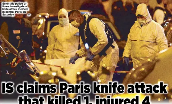  ?? AP ?? Scientific police officers investigat­e a knife attack incident in central Paris on Saturday.