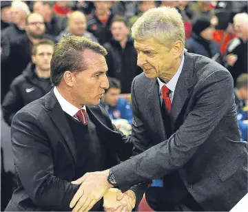  ??  ?? Brendan Rodgers with Arsene Wenger before a Premiershi­p game at Anfield.