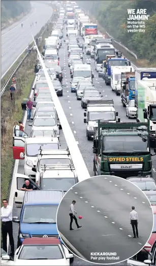  ??  ?? KICKAROUND Pair play football WE ARE JAMMIN’ Motorists on the M5 yesterday