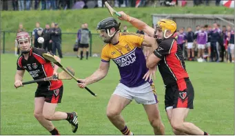  ??  ?? David Mooney (Faythe Harriers) is pressurise­d by Oulart-The Ballagh’s David Redmond in their Pettitt’s SHC encounter in Bellefield on Sunday as Nicky Kirwan awaits the outcome.