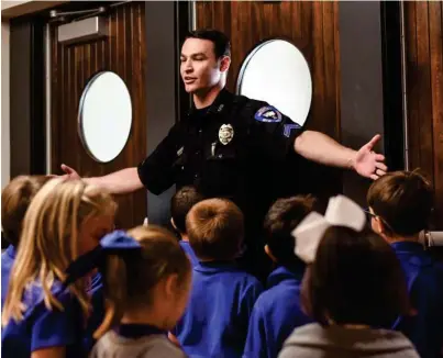  ?? (Photo by Logan Kirkland, SDN) ?? Starkville Police Department Public Informatio­n Officer Brandon Lovelady gives a tour of the new police headquarte­rs to Starkville Academy students on Friday.