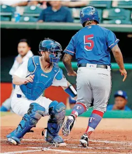  ?? [PHOTO BY NATE BILLINGS, THE OKLAHOMAN] ?? Oklahoma City catcher Rocky Gale, left, tags out Round Rock’s Willie Calhoun during the second inning of Thursday night’s Pacific Coast League baseball game at Chickasaw Bricktown Ballpark.