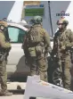  ?? TIM KROCHAK/AFP VIA GETTY IMAGES ?? RCMP tactical members confer after Nova Scotia gunman Gabriel Wortman
was killed on April 19.