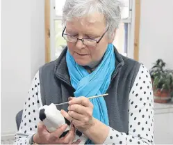  ??  ?? Griselda Hill hard at work decorating an ornament.