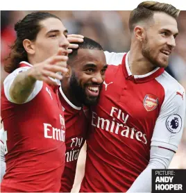  ??  ?? Easy street: Bellerin (left) and Ramsey (right) mob Lacazette ANDY HOOPER PICTURE: