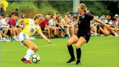  ?? Natalie Howard/JBU Sports Informatio­n ?? John Brown sophomore Emily Jordan, left, makes a move on Bellevue (Neb.) forward Emily Weyant on Friday in the Golden Eagles’ 1-0 victory at Alumni Field.