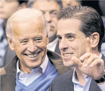  ?? REUTERS ?? Former vice president Joe Biden and his son Hunter Biden are seen at a basketball game. Hunter Biden will step down from the board of a Chinese-backed equity firm as a pledge to not work for foreign enterprise­s if his father wins the presidency.