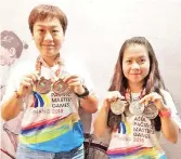  ??  ?? IMPRESSIVE DUO: Sabah riders June (left) and Anita brandishin­g the medals won at the APMG 2018 in Penang.