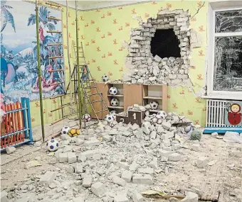  ?? OLEKSANDR R AT U S H N I A K THE ASSOCIATED PRESS ?? Debris mixes with toys below a damaged wall after the reported shelling on a kindergart­en class in Stanytsia Luhanska, Ukraine, on Thursday.