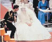  ??  ?? Prince Charles speaks with Diana during their wedding ceremony in St. Paul’s Cathedral in London on July 29, 1981. Her silk taffeta gown by David and Elizabeth Emanuel featured a 7.6-metre train.