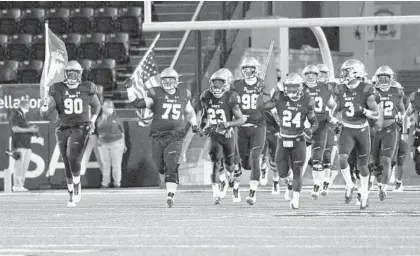  ?? PAUL W. GILLESPIE/CAPITAL GAZETTE ?? Navy football players take the field before its season-opening game against BYU on Labor Day. The Midshipmen take on Tulane Saturday in their first road game.