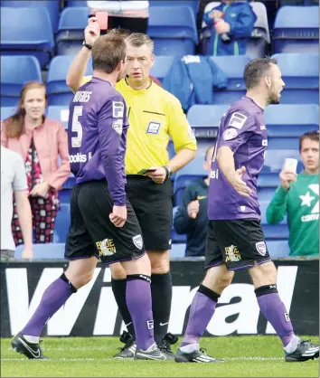  ??  ?? ON YOUR BIKE: Morecambe's Mark Hughes is shown the red card