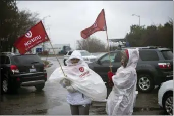  ?? EDUARDO LIMA — THE CANADIAN PRESS VIA AP ?? Members of Unifor, the union representi­ng the workers of Oshawa’s General Motors assembly plant, stand near the entrance to the plant in Oshawa, Ontario, Monday. General Motors will lay off thousands of factory and white-collar workers in North America and put five plants up for possible closure as it restructur­es to cut costs and focus more on autonomous and electric vehicles. General Motors is closing the Oshawa plant.