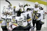  ?? MARCIO JOSE SANCHEZ — THE ASSOCIATED PRESS ?? Vegas Golden Knights players hug after a 3-0 win over the San Jose Sharks during Game 6 of an NHL hockey secondroun­d playoff series, Sunday in San Jose