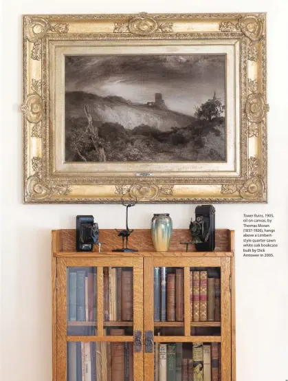  ??  ?? Tower Ruins, 1905, oil on canvas, by Thomas Moran (1837-1926), hangs above a Limbertsty­le quarter-sawn white oak bookcase built by Dick Amtower in 2005.