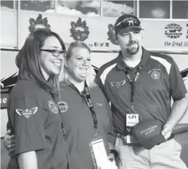  ?? AP PHOTO ?? Jennifer Simonds, left, Anna "Sam" Canaday, center, teachers at Moore’s Plaza Towers Elementary School, gave the command to start engines at Saturday night’s IndyCar race at Texas Motor Speedway. CJ Gillaspie, right, of West, Texas, was the honorary...