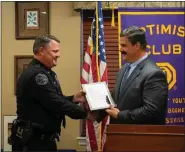  ??  ?? Amity Township Police Officer Brian Devlin receives the Daniel Boone Optimist Club Officer of the Year Award from District Judge Steven Chieffo.