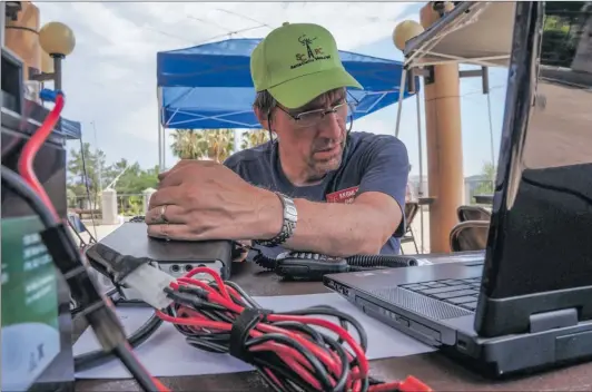  ?? Samie Gebers/The Signal ?? Chris Edwards attempts to find other Field Day participan­ts on his ham radio during the W6JW Santa Clarita Radio Club Field Day at the Castaic Lake Water Agency on Saturday.