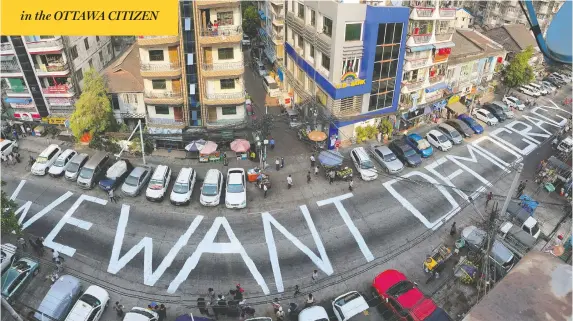  ?? REUTERS ?? Words decrying the Feb. 1 coup in Myanmar are seen on a street in Yangon on Sunday. The killings of two protesters Saturday have further stoked pro-democracy demonstrat­ions.