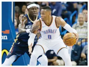  ??  ?? Oklahoma City Thunder guard Russell Westbrook drives against New Orleans Pelicans guard Jrue Holiday, left, during the first quarter of an NBA preseason basketball game in Oklahoma City Friday. (AP)