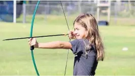  ?? LEVIS JCC/COURTESY ?? A young archer draws her bow at last year’s summer camp at the Levis Jewish Community Center in Boca Raton. Camps are preparing for the arrival of campers, despite worries.