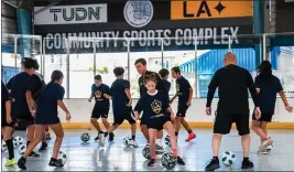  ?? COURTESY OF MAJOR LEAGUE SOCCER/LA GALAXY ?? The Galaxy’s youth camp members play futsal at the Charles H. Wilson park indoor sports facility. The team, along with the TUDN network is providing funding for the facility.
